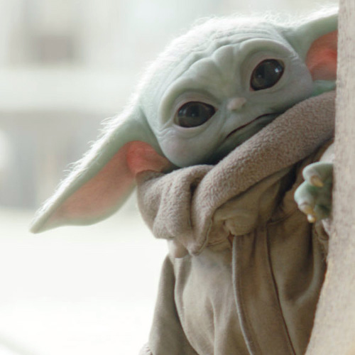 Baby Yoda peeks out from around a corner.