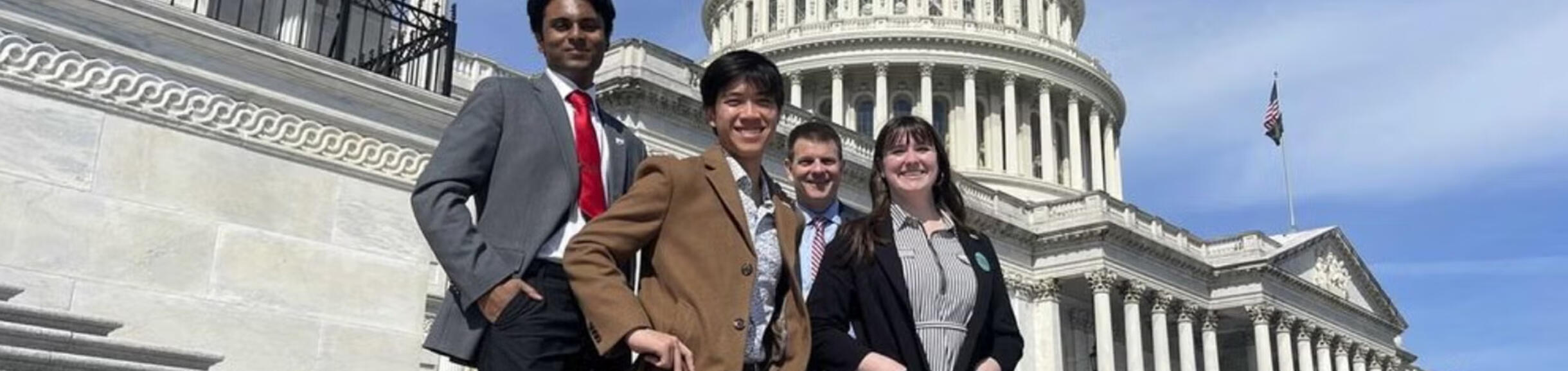 Four students from the University of California’s UCDC program pose in front of the U.S. Capitol dome in Washington, D.C.